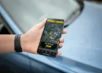 A man with a watch holding his phone