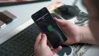 A man using fingerprint authentication on a new phone