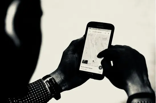 A person using his phone to look at maps