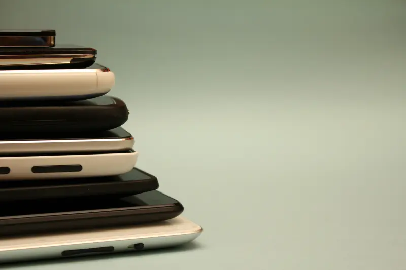 Multiple smart phones stacked on top of each other