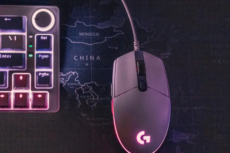 A gaming mouse with led lights on a mouse pad