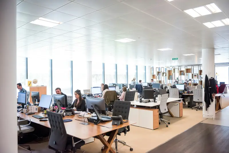 An open plan office with people working at their desks